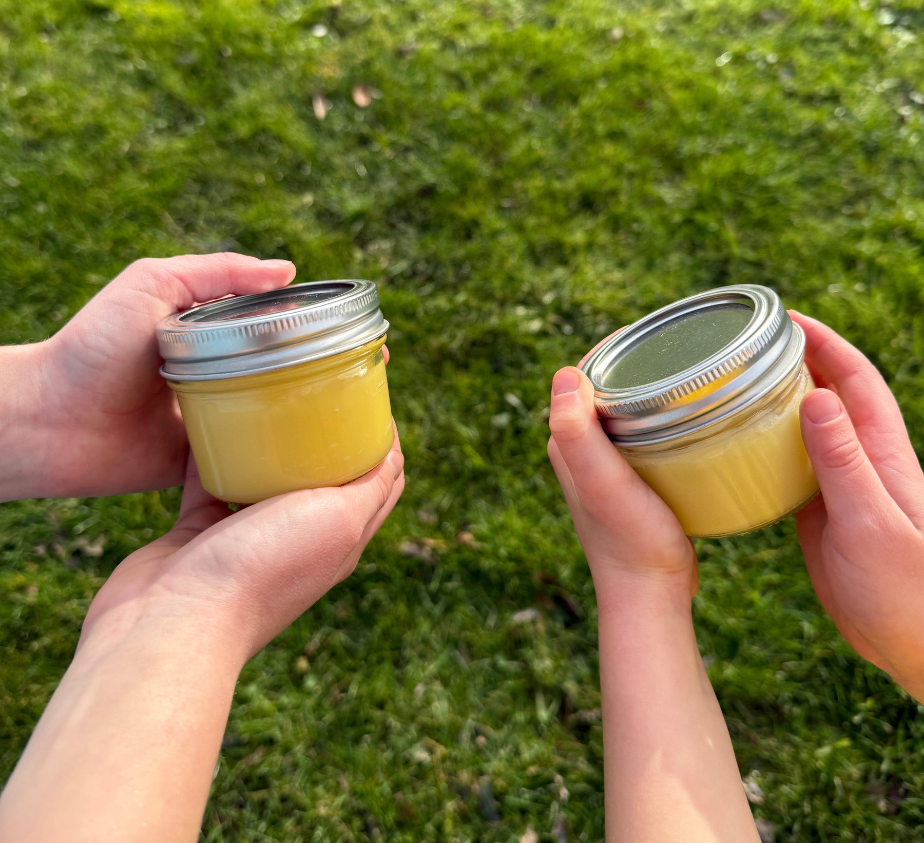 Alfeo tallow balms held outdoors